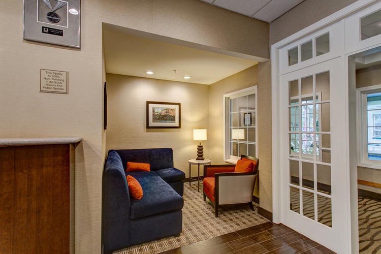 Lobby area with seating area with white doors to facilities