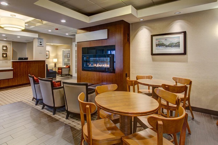 Tables and chairs in lobby beside fireplace