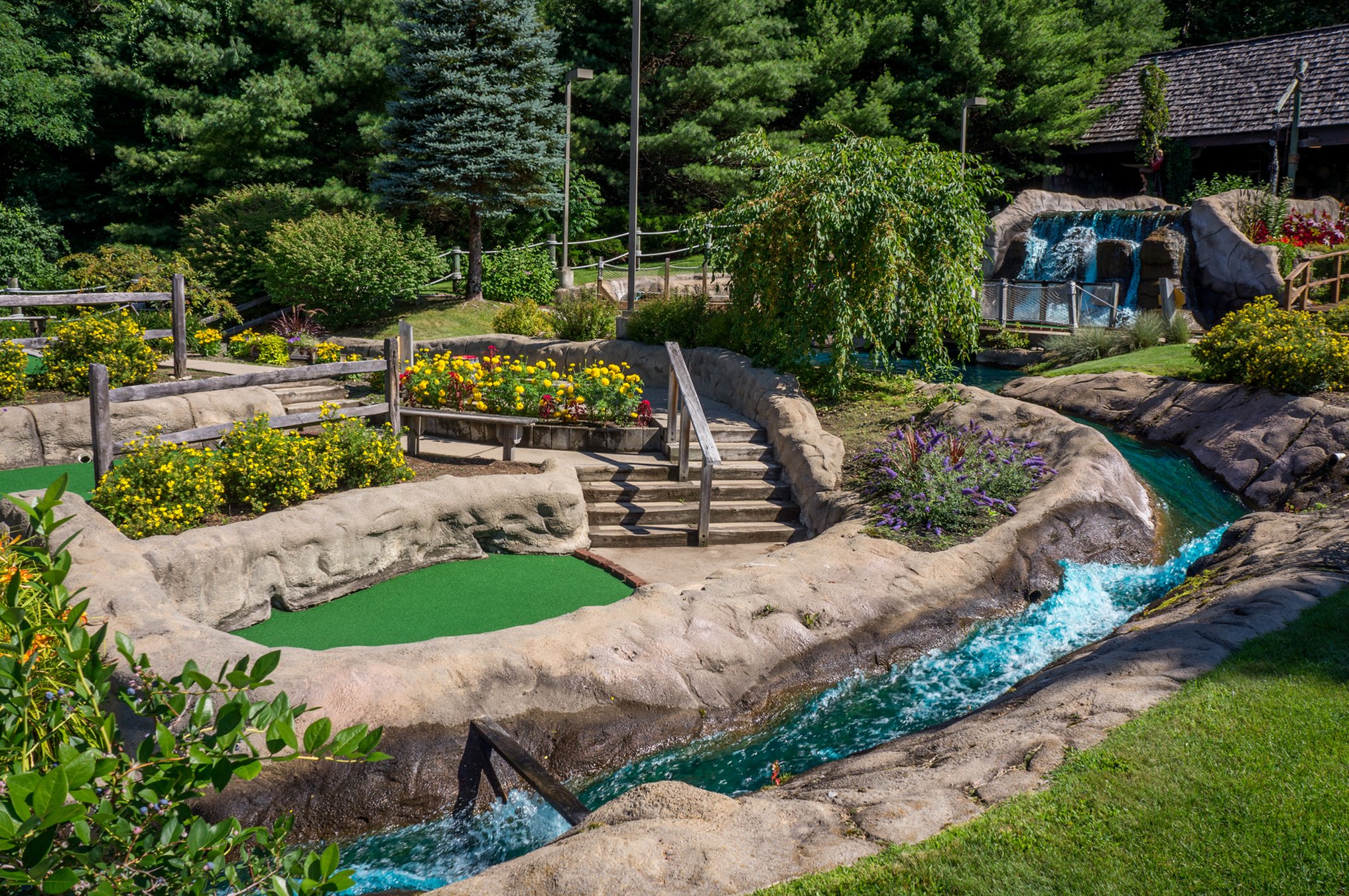 Mini golf course with greenery and water running through it